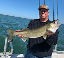 man holding walleye out