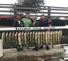 family standing with their walleye catch