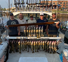men holding a full board and a half of fish