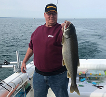man holding a big lake trout